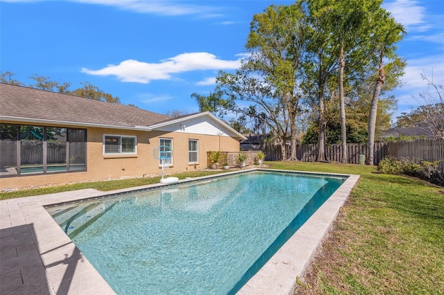 view of swimming pool with a lawn, a fenced backyard, and a fenced in pool