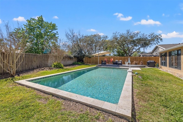 view of swimming pool with a fenced backyard, a fenced in pool, a patio, and a yard