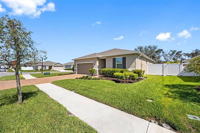 view of front of home featuring fence, decorative driveway, a gate, stucco siding, and a front lawn