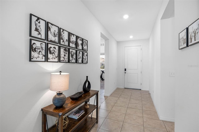 doorway featuring light tile patterned floors, recessed lighting, and baseboards