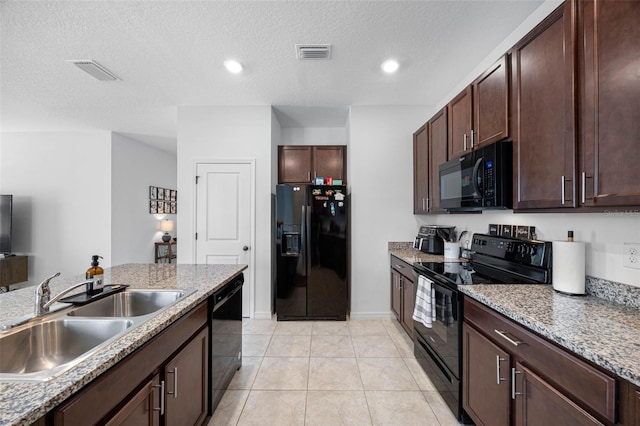 kitchen featuring black appliances, light tile patterned floors, visible vents, and a sink