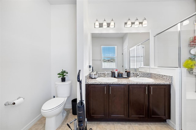 full bathroom featuring a stall shower, a sink, toilet, and double vanity