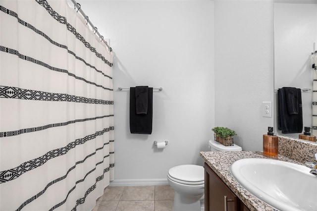 bathroom with toilet, vanity, a shower with curtain, baseboards, and tile patterned floors