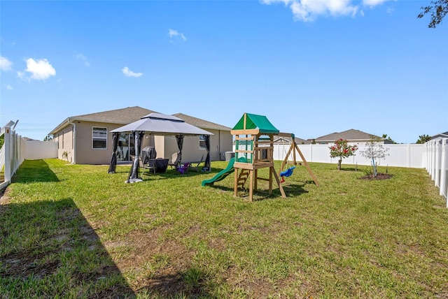 view of playground with a yard, central AC, a gazebo, and a fenced backyard