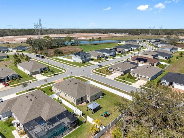 drone / aerial view featuring a residential view and a water view