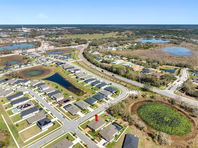 drone / aerial view featuring a residential view and a water view