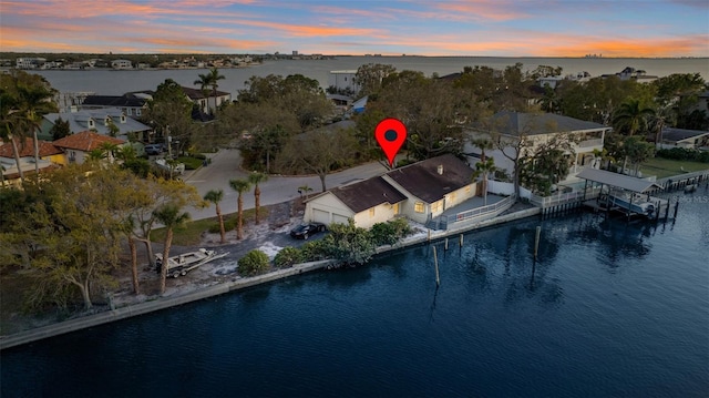 aerial view at dusk with a water view