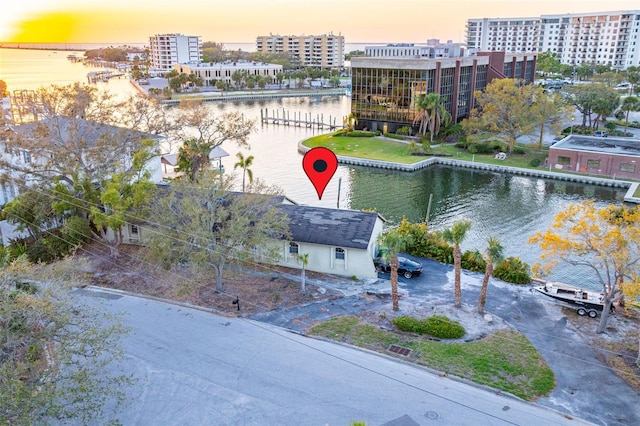 birds eye view of property featuring a water view and a view of city