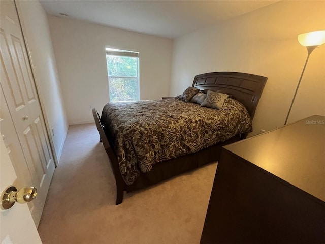 bedroom featuring light carpet