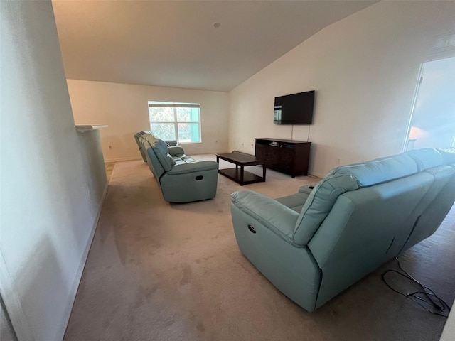 living room featuring light carpet, baseboards, and lofted ceiling