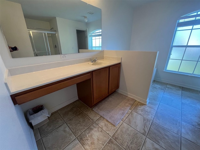 full bath featuring a healthy amount of sunlight, a stall shower, visible vents, and vanity