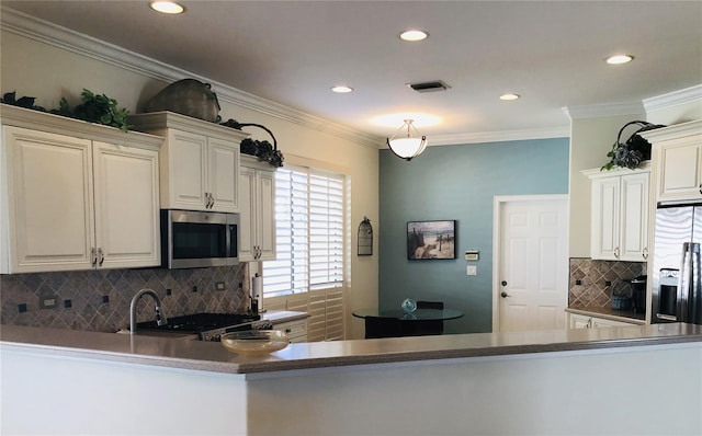 kitchen featuring recessed lighting, stainless steel appliances, visible vents, decorative backsplash, and crown molding