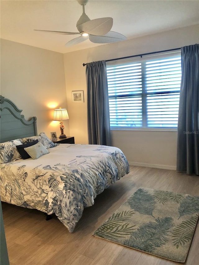 bedroom with a ceiling fan and wood finished floors