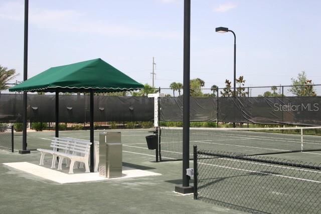 view of tennis court featuring fence