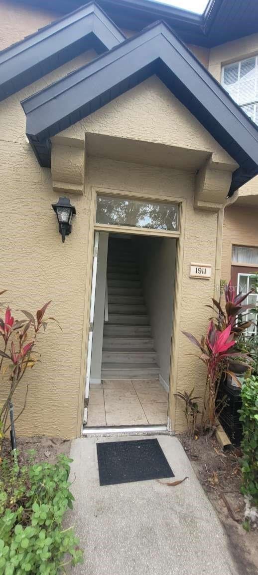 entrance to property featuring stucco siding