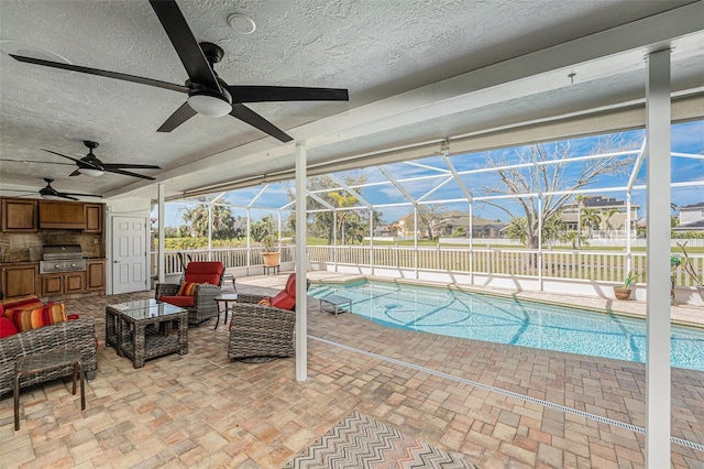 view of pool featuring a lanai, an outdoor living space, grilling area, a fenced in pool, and a patio area