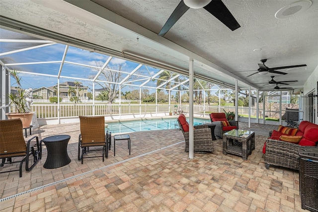 view of patio / terrace with a ceiling fan, a lanai, a fenced backyard, and outdoor lounge area