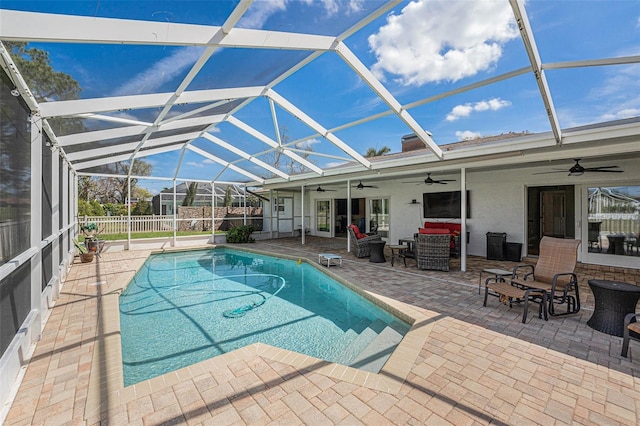 view of swimming pool featuring a lanai, fence, a ceiling fan, a fenced in pool, and a patio area