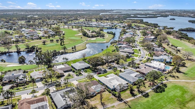 birds eye view of property featuring view of golf course, a water view, and a residential view