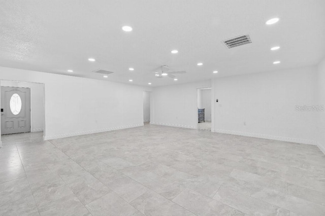 empty room with ceiling fan, recessed lighting, visible vents, and baseboards