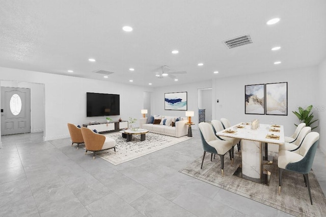 living area featuring visible vents and recessed lighting