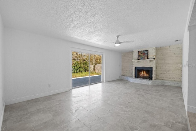 unfurnished living room with a textured ceiling, a fireplace, visible vents, a ceiling fan, and baseboards