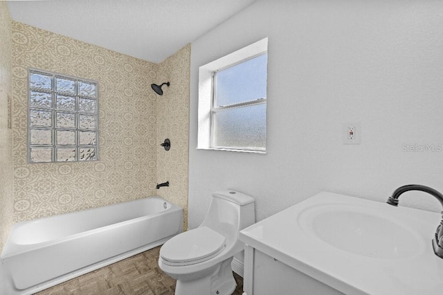 full bathroom with  shower combination, a textured ceiling, toilet, and vanity