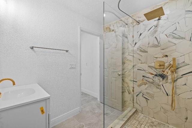 full bathroom featuring baseboards, vanity, and a marble finish shower