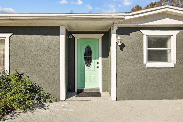 entrance to property with stucco siding