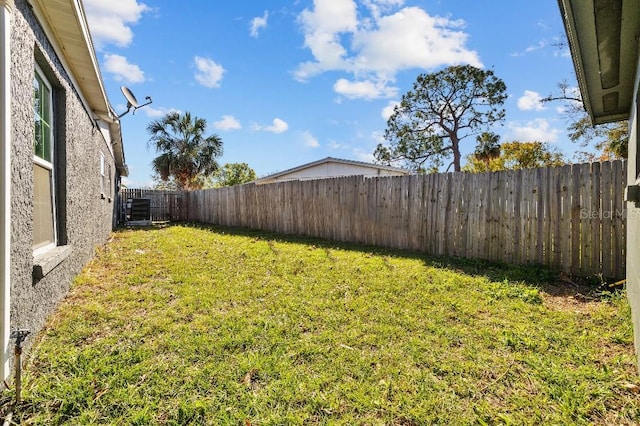 view of yard featuring a fenced backyard and central air condition unit