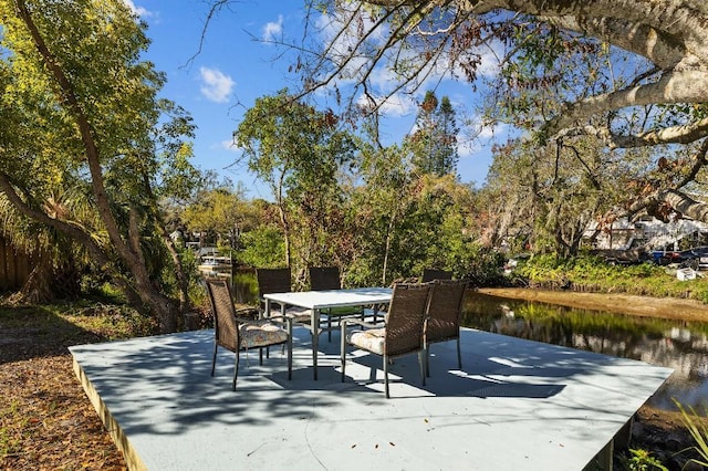 view of patio / terrace featuring outdoor dining area and a water view