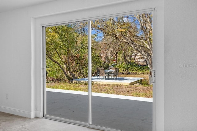 doorway featuring baseboards