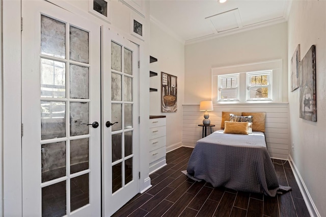 bedroom with wainscoting, ornamental molding, french doors, and wood finish floors