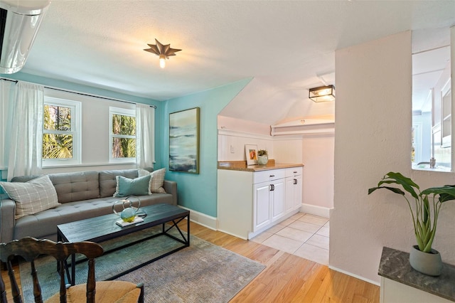 living room with light wood-type flooring and baseboards