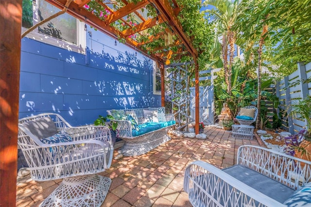 view of patio / terrace with fence, an outdoor living space, and a pergola