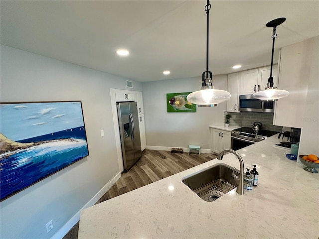 kitchen featuring stainless steel appliances, a sink, visible vents, and light stone countertops