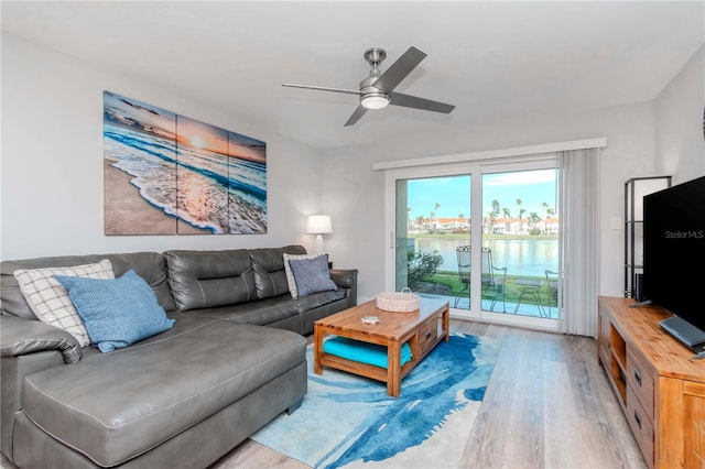 living room featuring a ceiling fan and wood finished floors