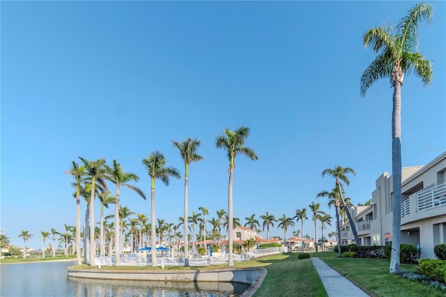 exterior space with a yard, a water view, and a residential view