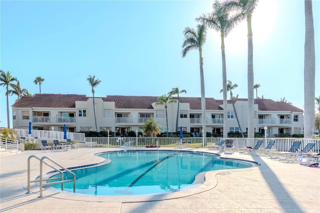 pool featuring a patio area and fence