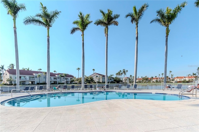 pool featuring a residential view, fence, and a patio