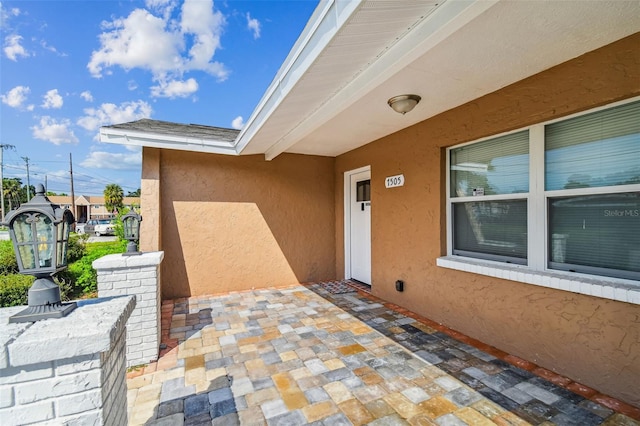 entrance to property with stucco siding