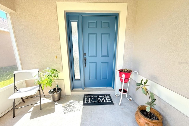 view of exterior entry featuring stucco siding