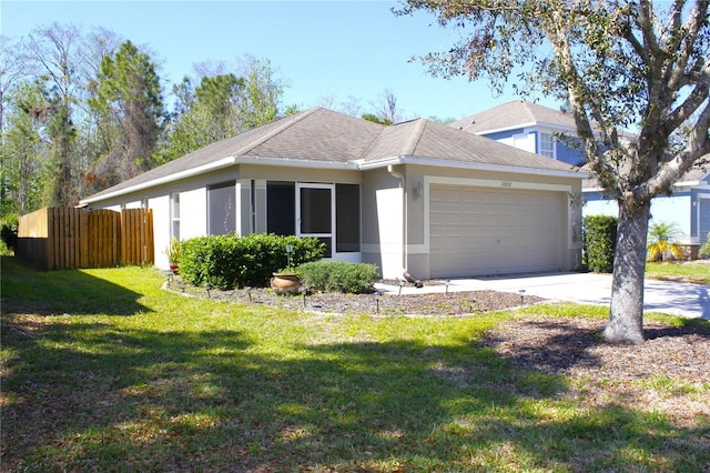 ranch-style house featuring a front lawn, fence, concrete driveway, stucco siding, and a garage