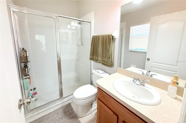 full bath with tile patterned floors, toilet, a stall shower, and vanity