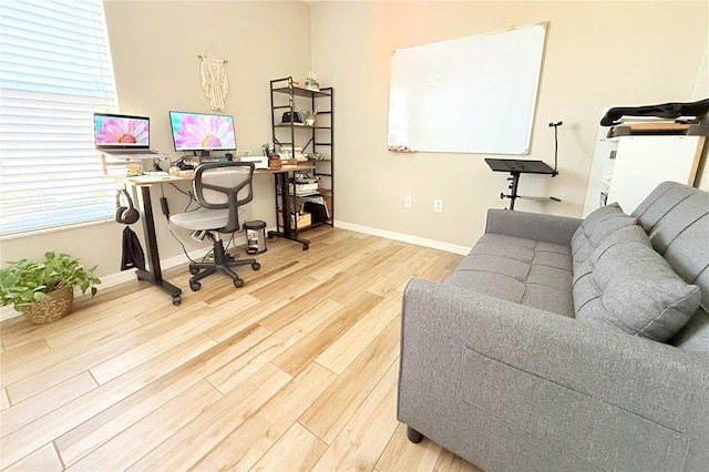 office area with baseboards and wood finished floors