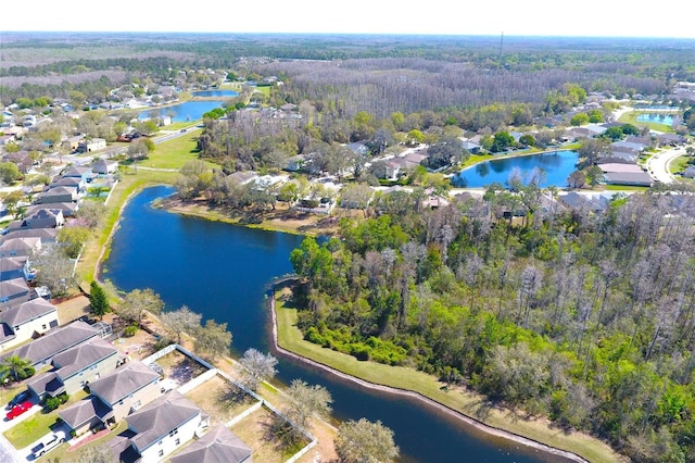 aerial view featuring a residential view, a forest view, and a water view