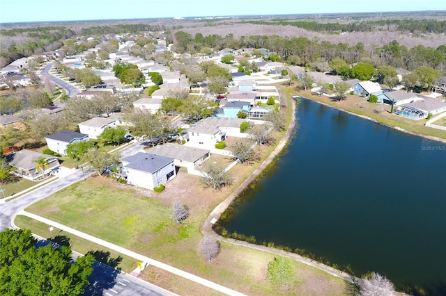 drone / aerial view featuring a residential view and a water view