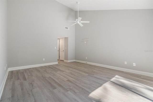 spare room with a ceiling fan, baseboards, visible vents, and light wood finished floors