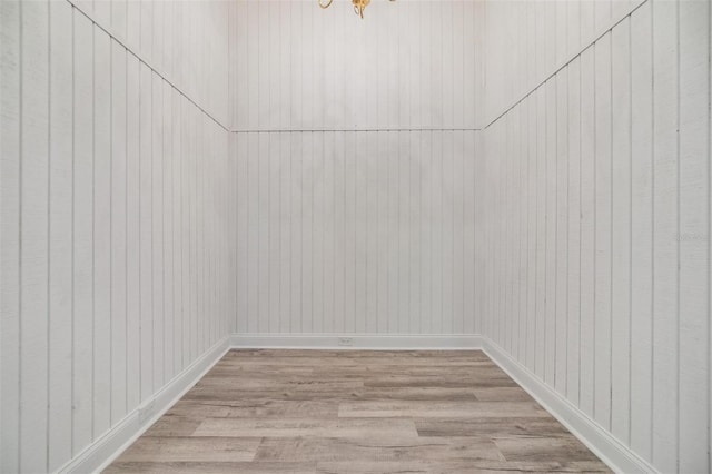 interior space featuring baseboards and wood finished floors