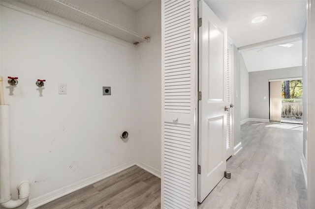 laundry area featuring laundry area, hookup for an electric dryer, baseboards, and light wood-style floors